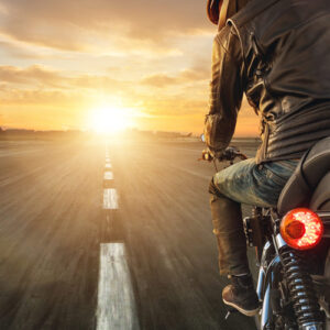 Man on motorcycle riding into the sunset, symbolizing renewed confidence after ED therapy in St. George.